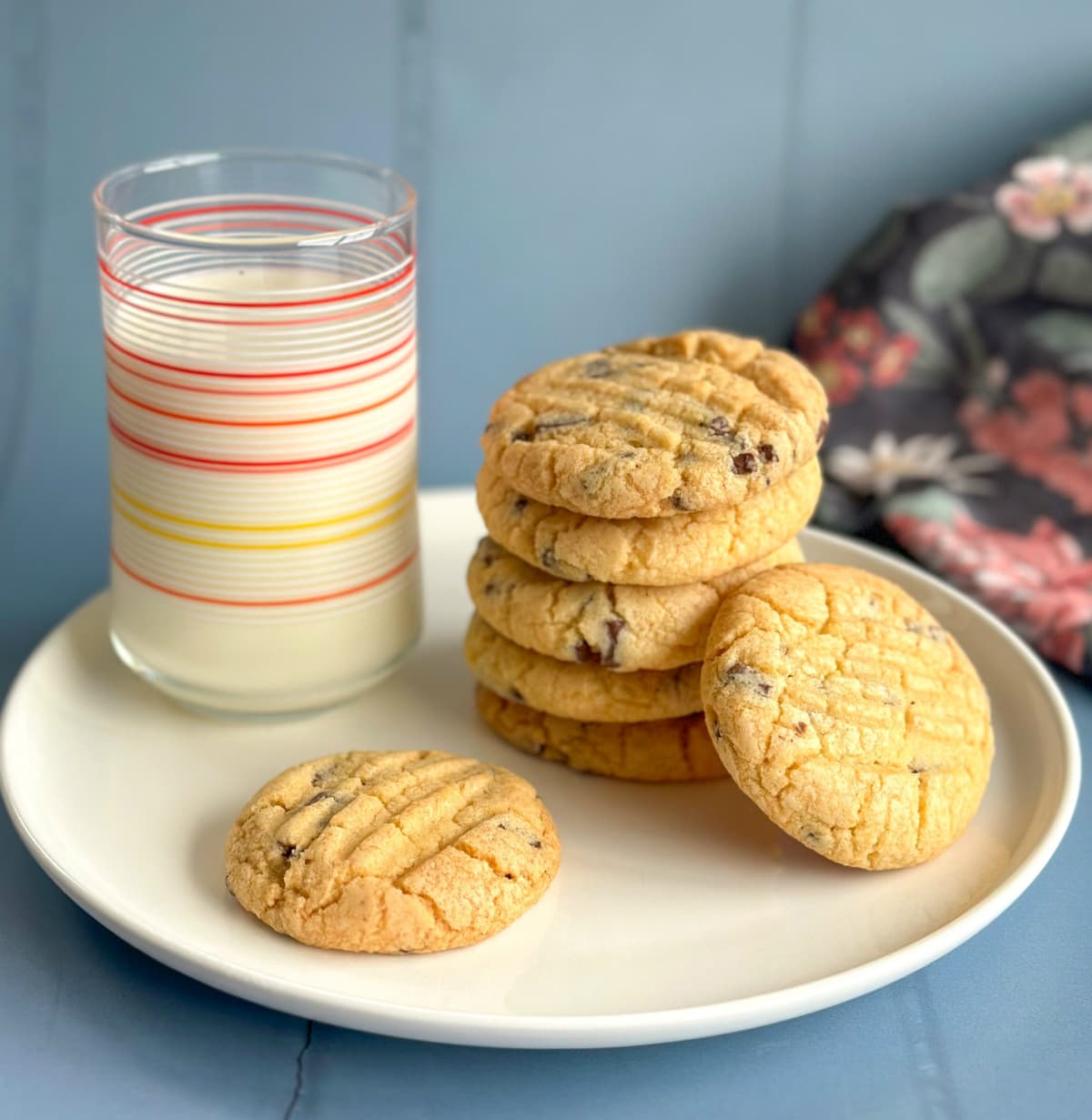 Stack of Mums Vanilla Biscuits on a white plate, next to a glass of Milk