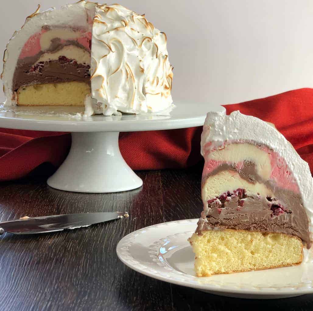 Slice of easy Baked Alaska with Neopolitan Ice Cream