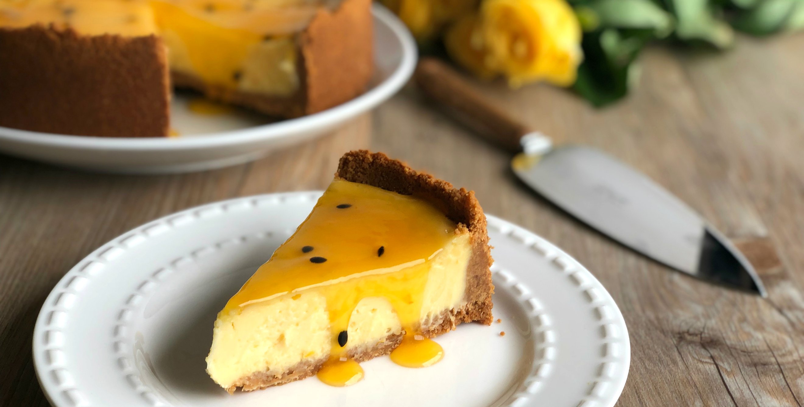 Slice of Easy Baked New York Cheesecake with Passionfruit Sauce