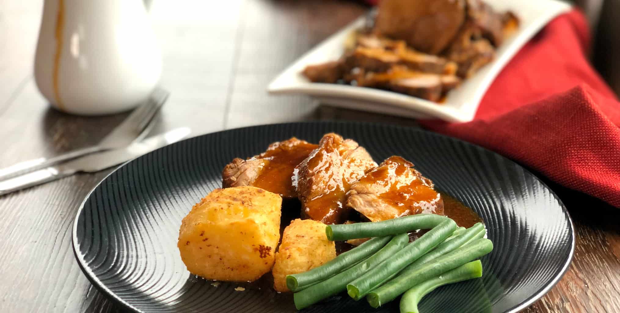 Roast Pork Dinner with Roast Potatoes and Green Beans