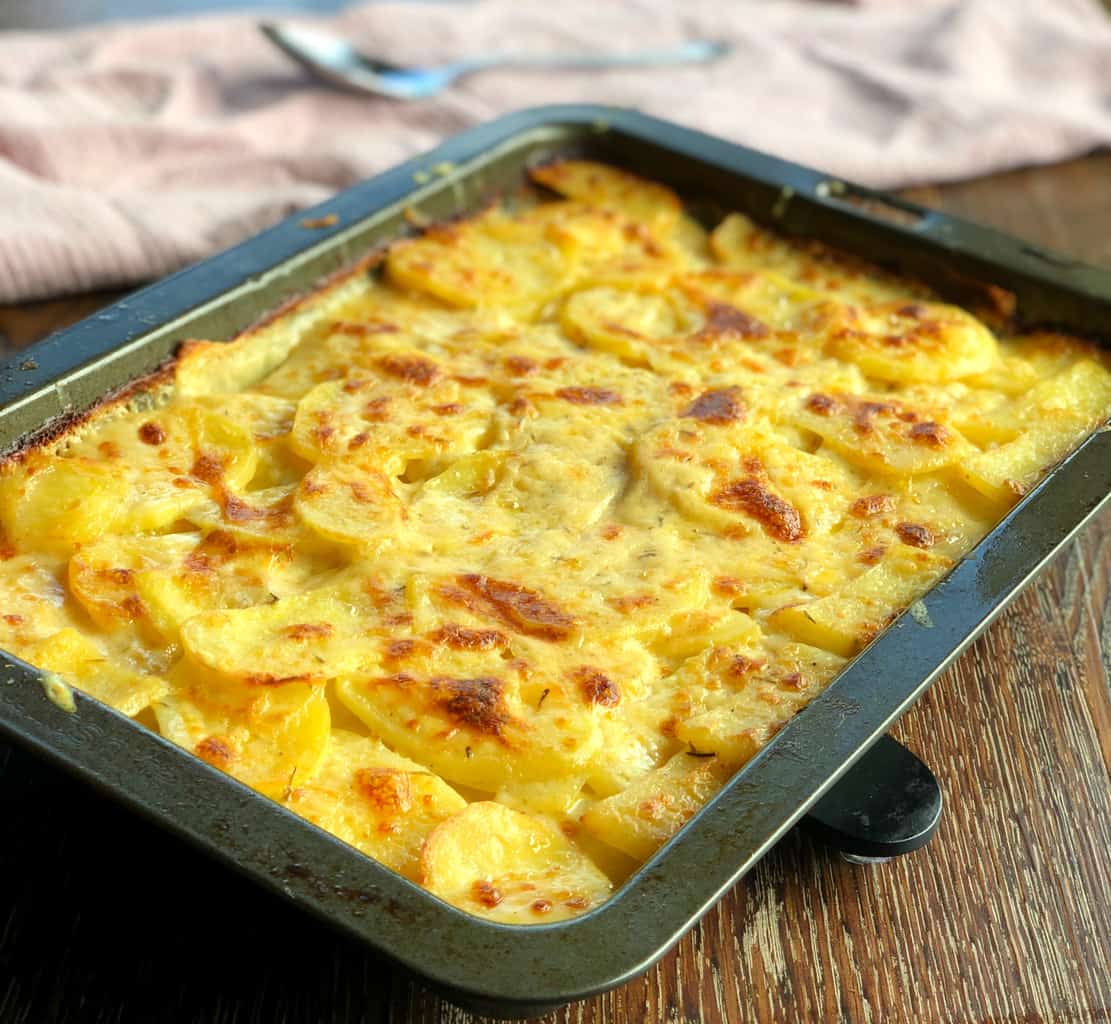 Tray of Potato Bake, including milk, cheese, chicken stock and garlic