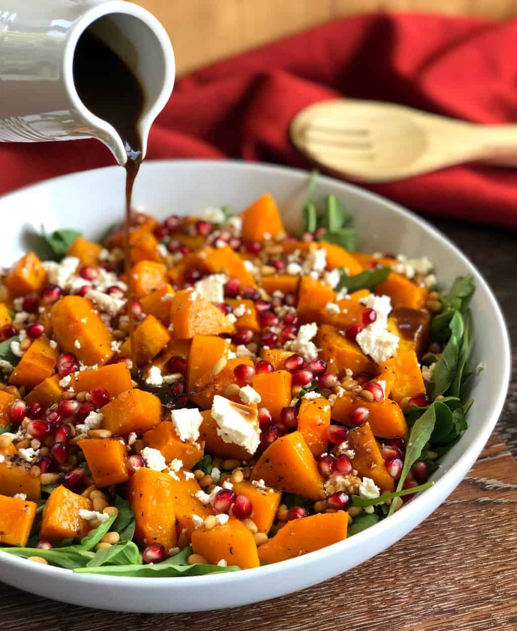 Pouring Balsamic Dressing over Salad