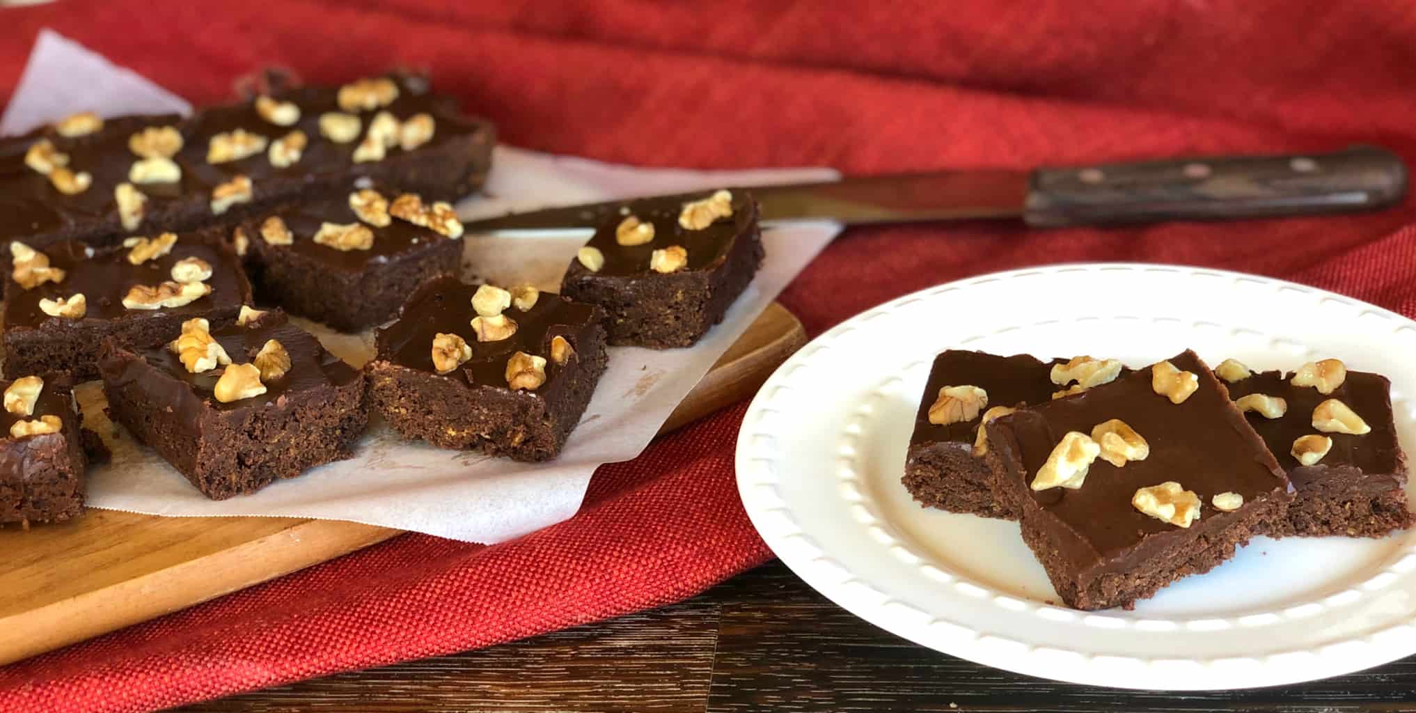 Photo of square pieces of Afghan Slice, a chocolate iced sliced with walnuts on top