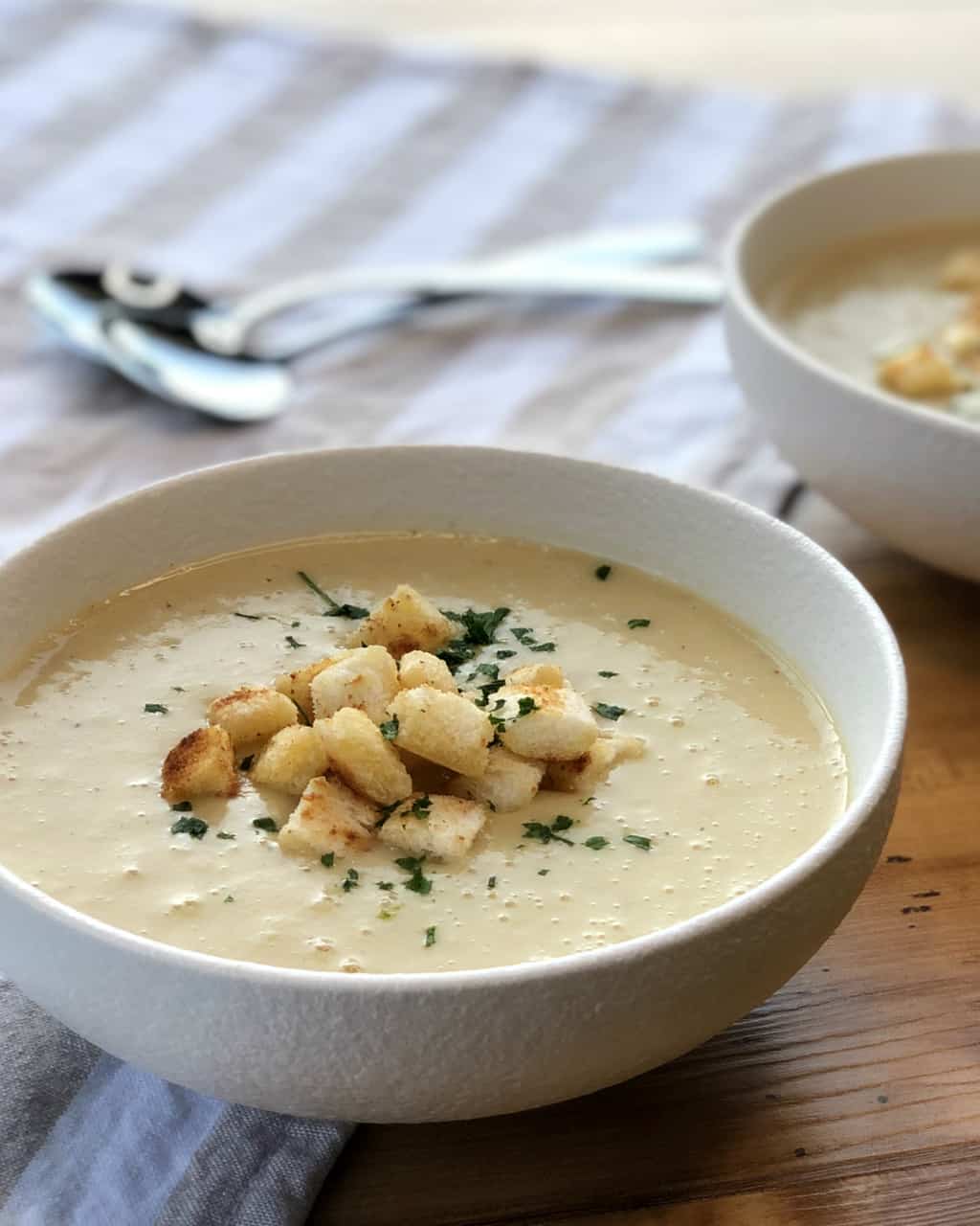 Bowl of Potato and Leak Soup with croutons and parsley