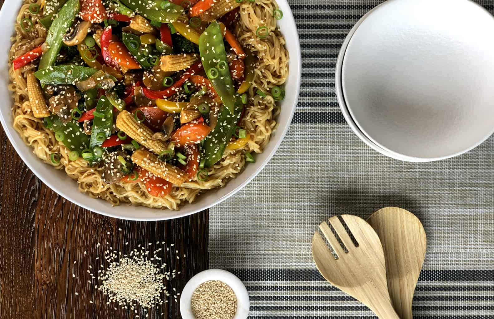 Overhead photo graph of a large bowl of vegetarian stir fry served over egg noodles