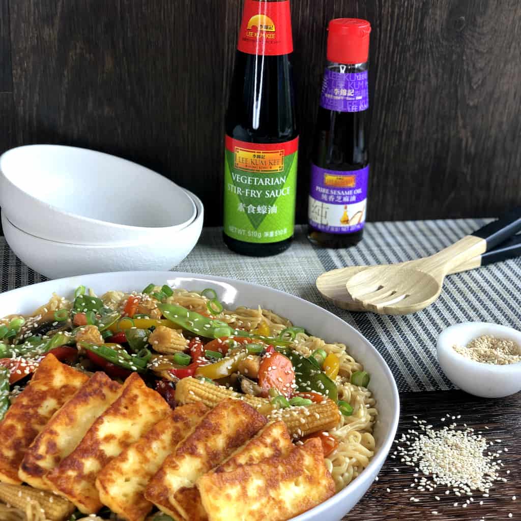 Bowl of Stir fried vegetables with pan friend halloumi and two bottles of Lee Kum Kee products