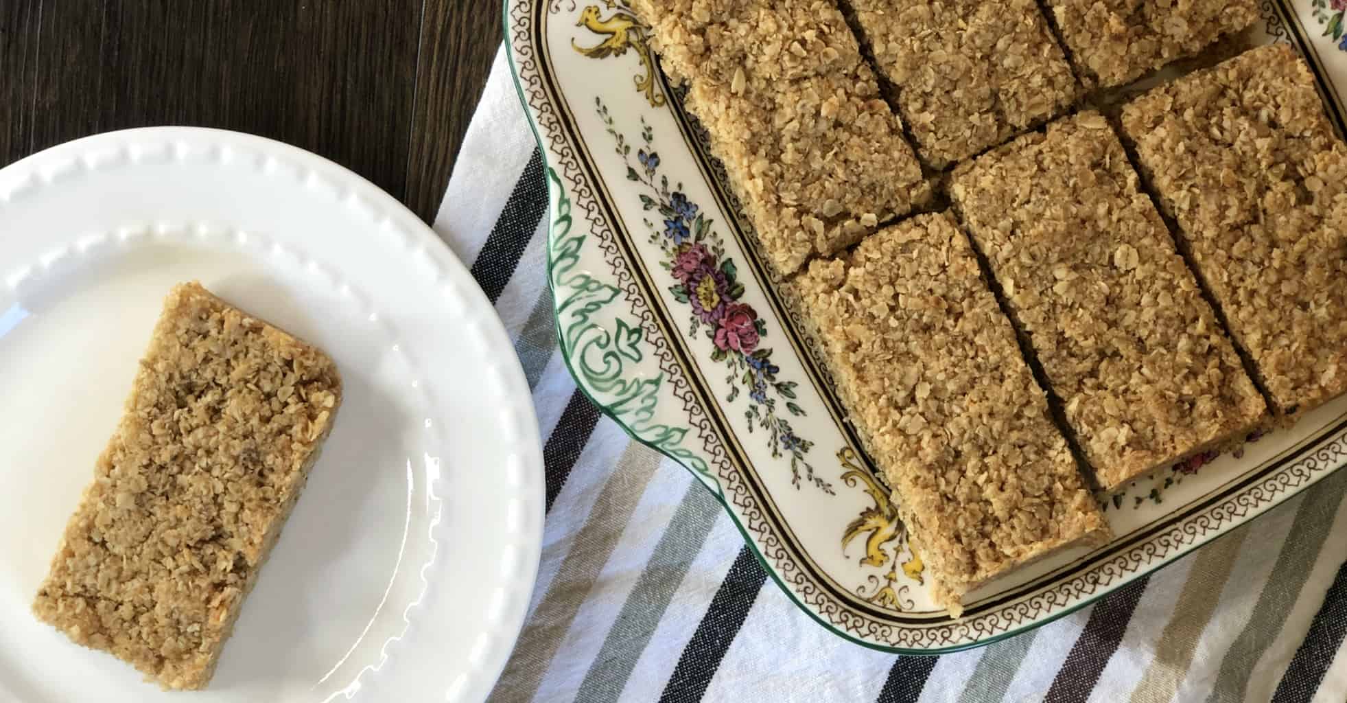 Slices of rolled oat crunch on a serving plate and a white plate