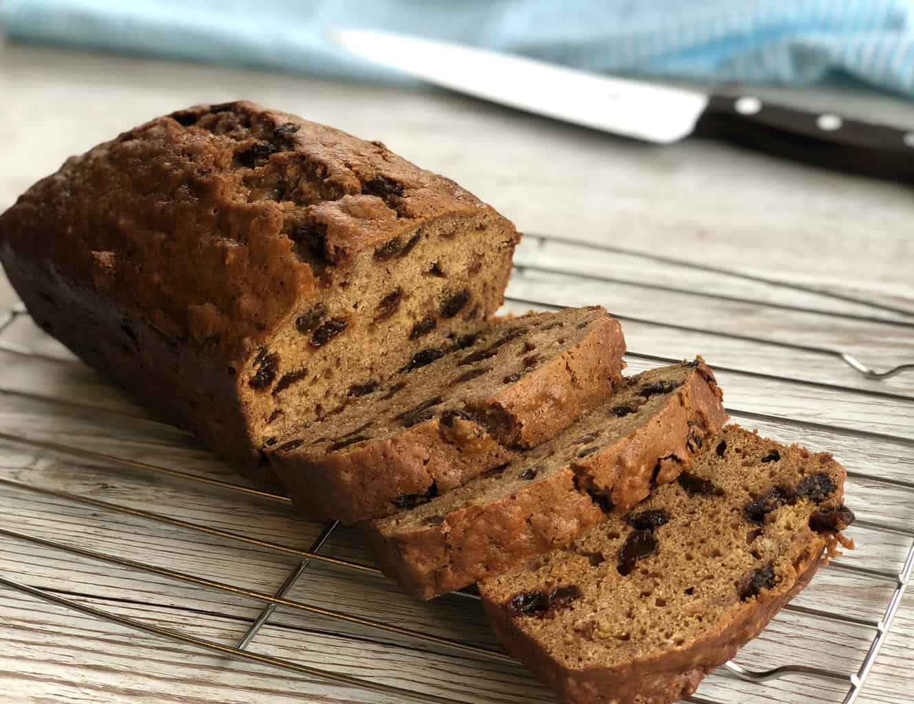 Sultana Loaf on a wire rack with three thick pieces sliced