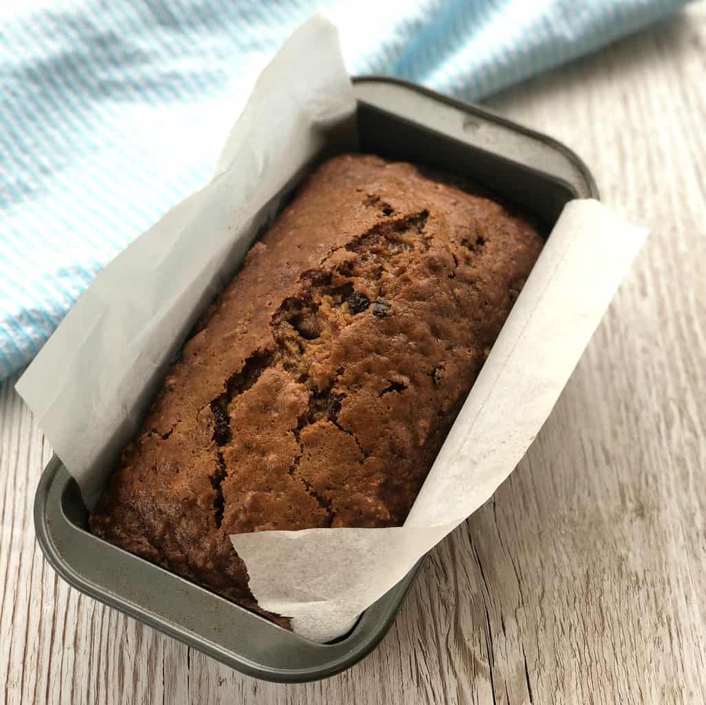 Sultana Loaf freshly baked in a baking tin lined with baking paper