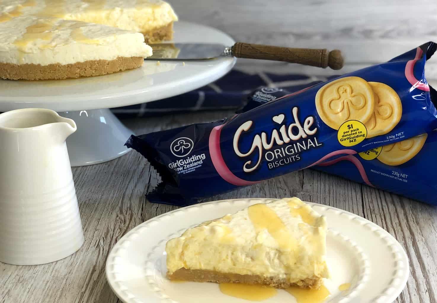 Girl Guide biscuits and a pineapple cheesecake with a jug of passionfruit glaze 