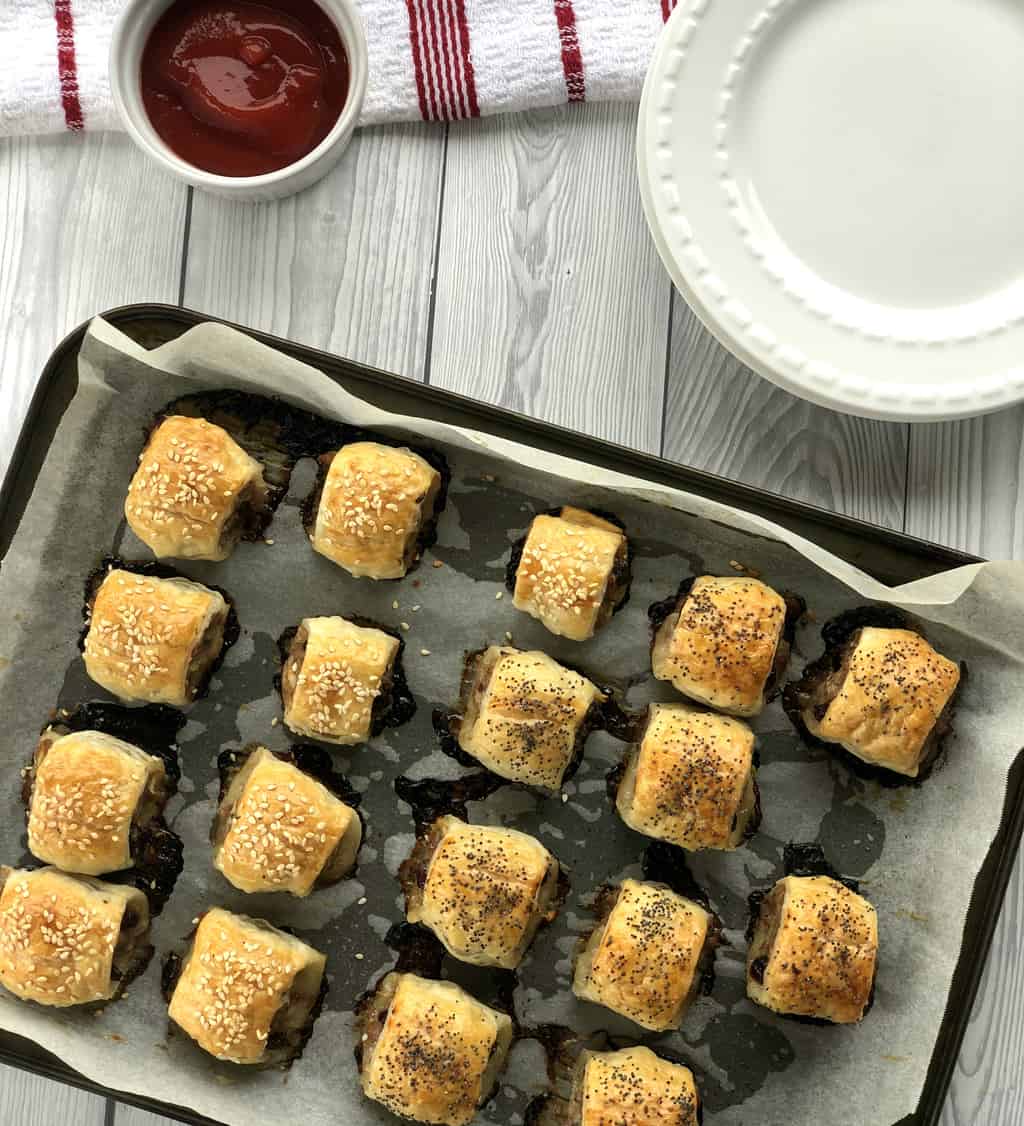 Overhead photograph of a warm sausage rolls with cranberries