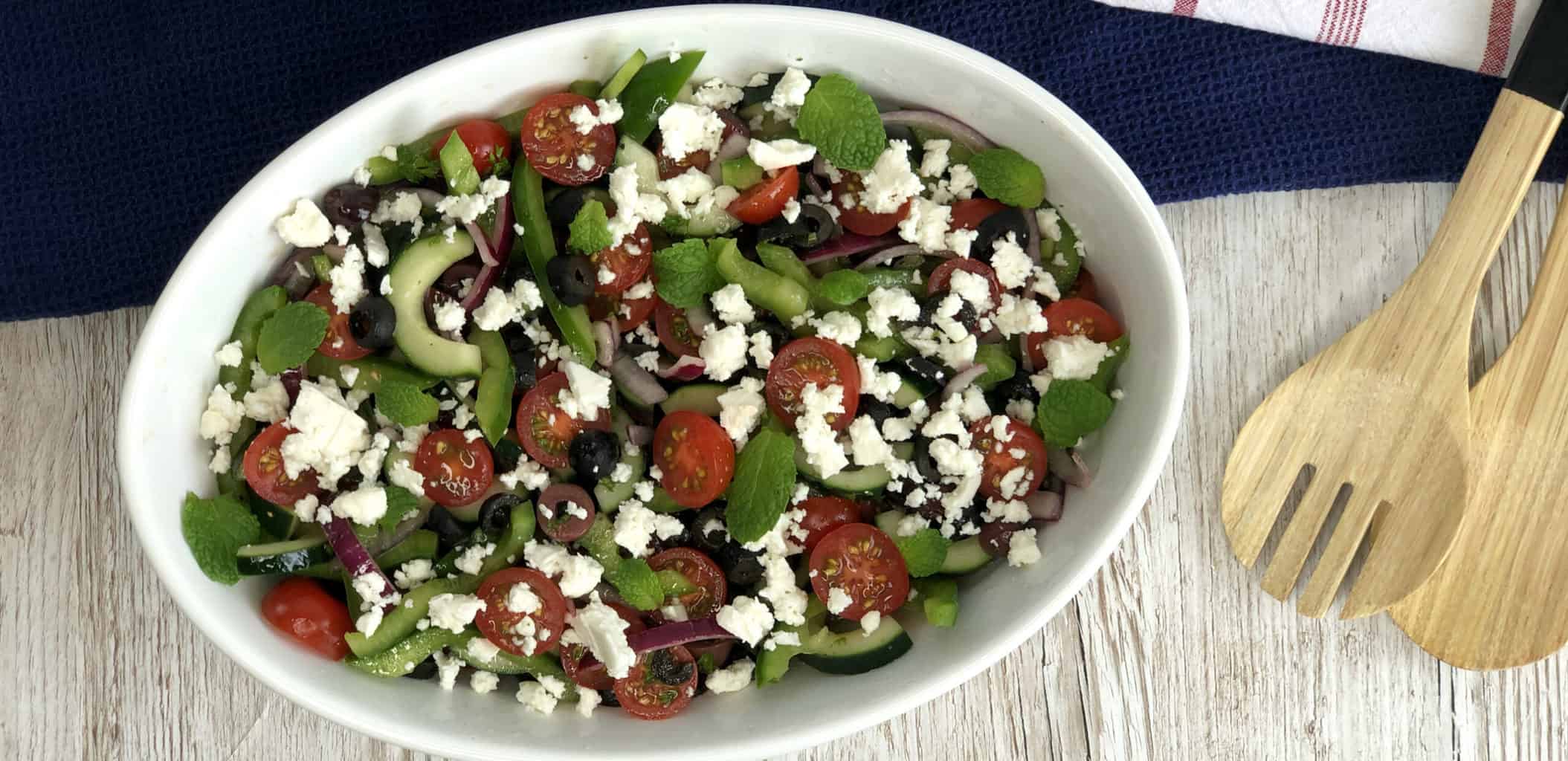 Overhead photo of a greek salad in a white bowl 