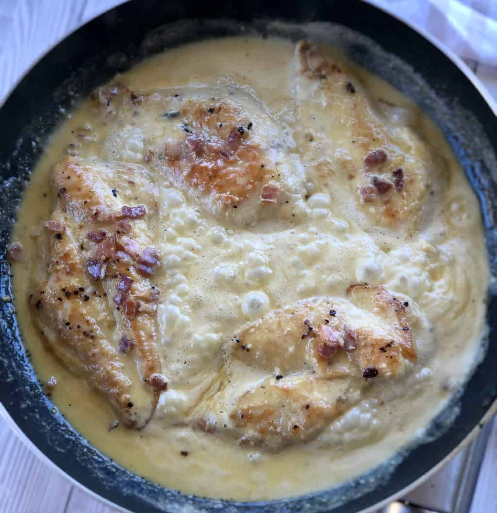 Chicken simmering in creamy bacon garlic sauce 