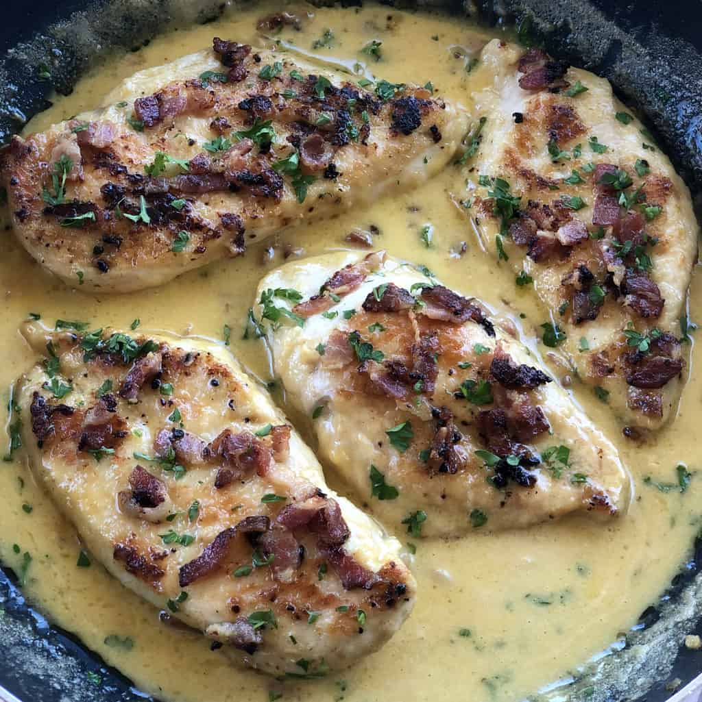 Creamy Bacon Garlic sauce with golden brown chicken breasts 