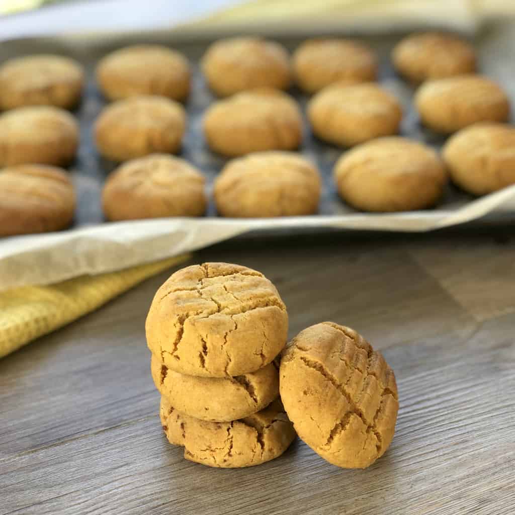 Hokey Pokey biscuits piled up in front of an oven tray 