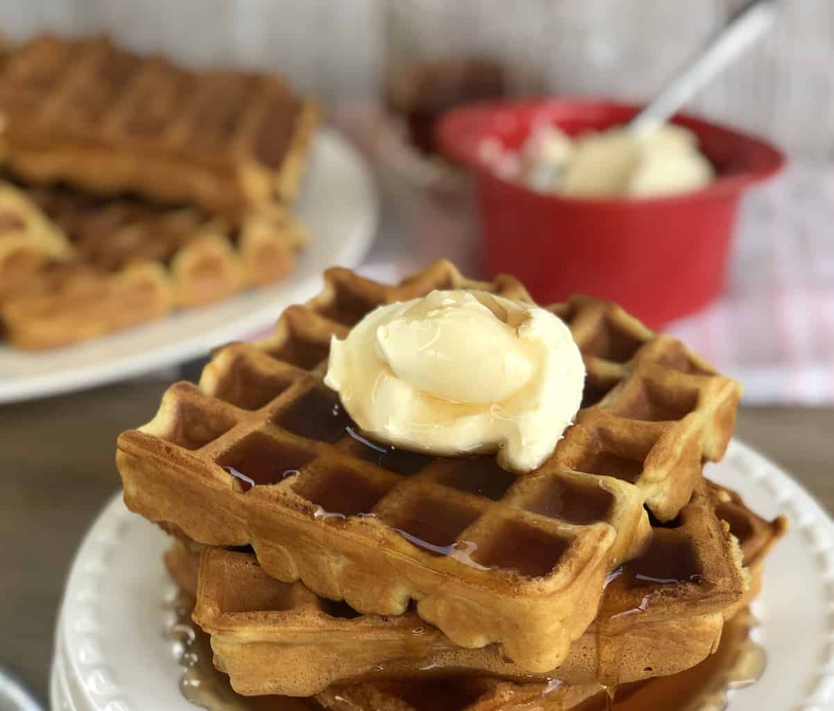 Plate of waffles with cream and maple syrup 