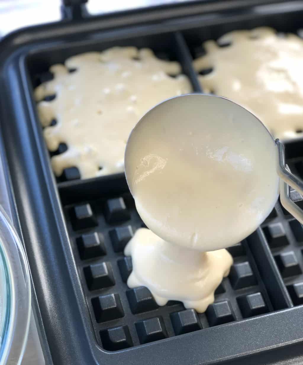 Pouring waffle batter into the waffle maker 