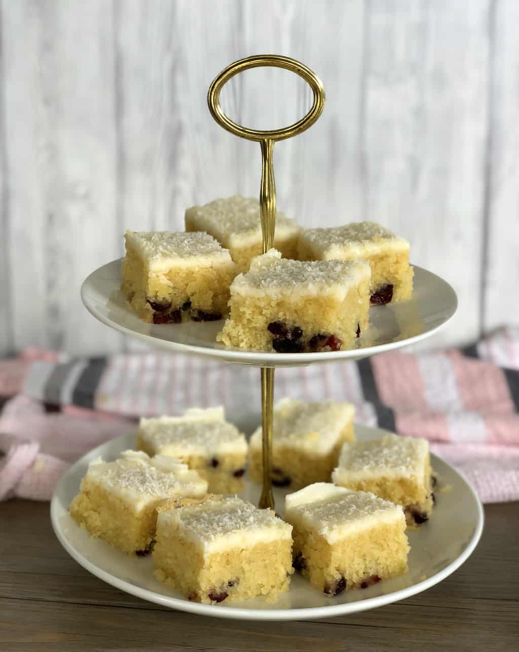 two tiered white serving plates with coconut slice 