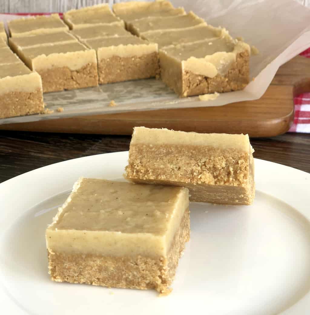 No Bake Ginger Slice, two pieces on a plate and the rest of the slice on a cutting board