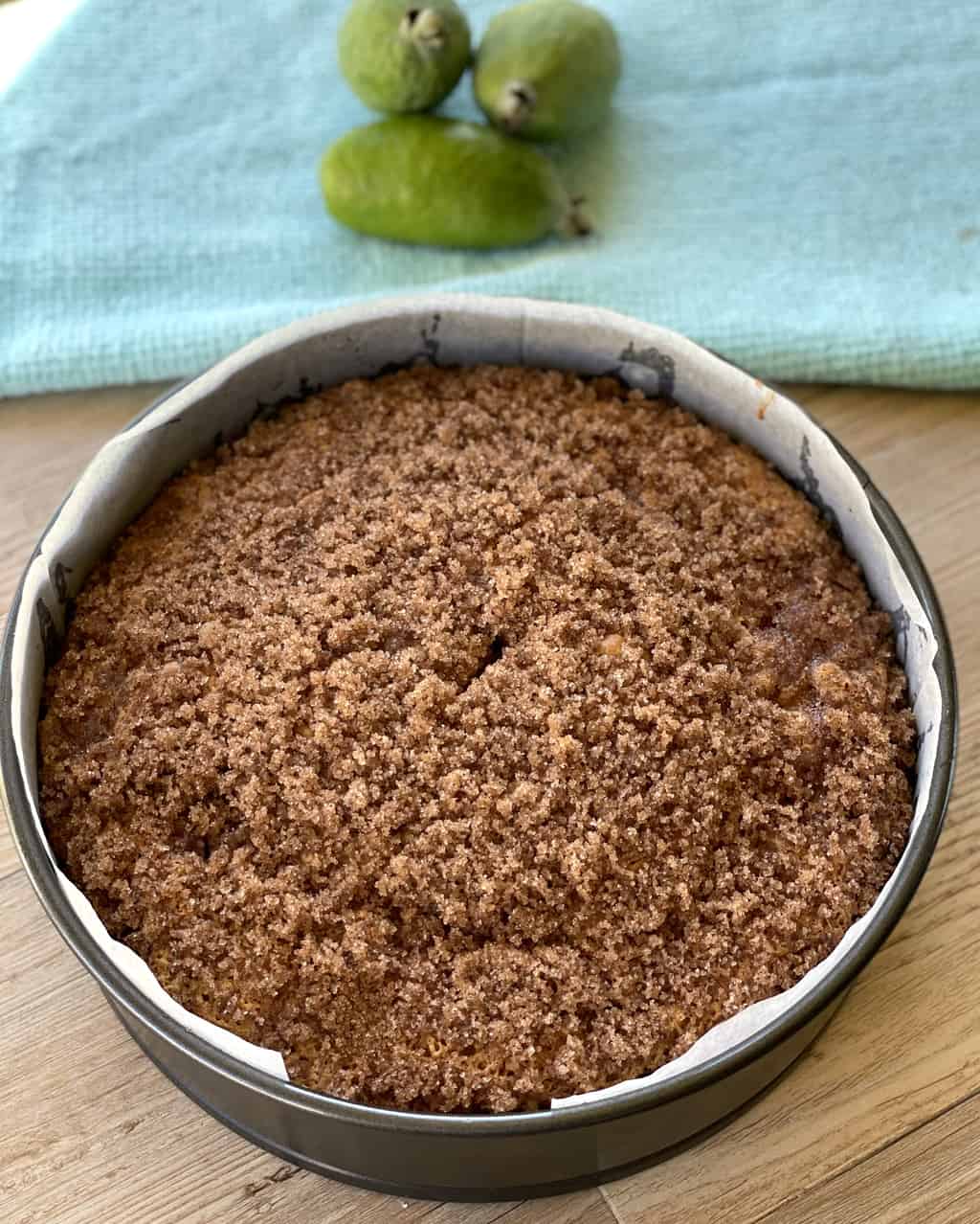 Freshly baked feijoa cake in a lined cake tin