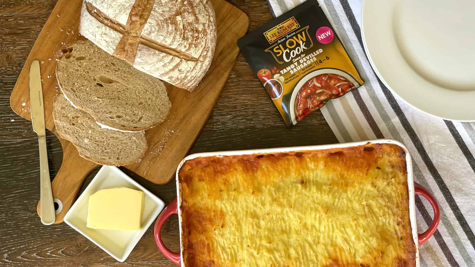 Overhead photograph of shepherds pie with loaf of bread and Lee Kum Kee Slow Cook Ready Sauce