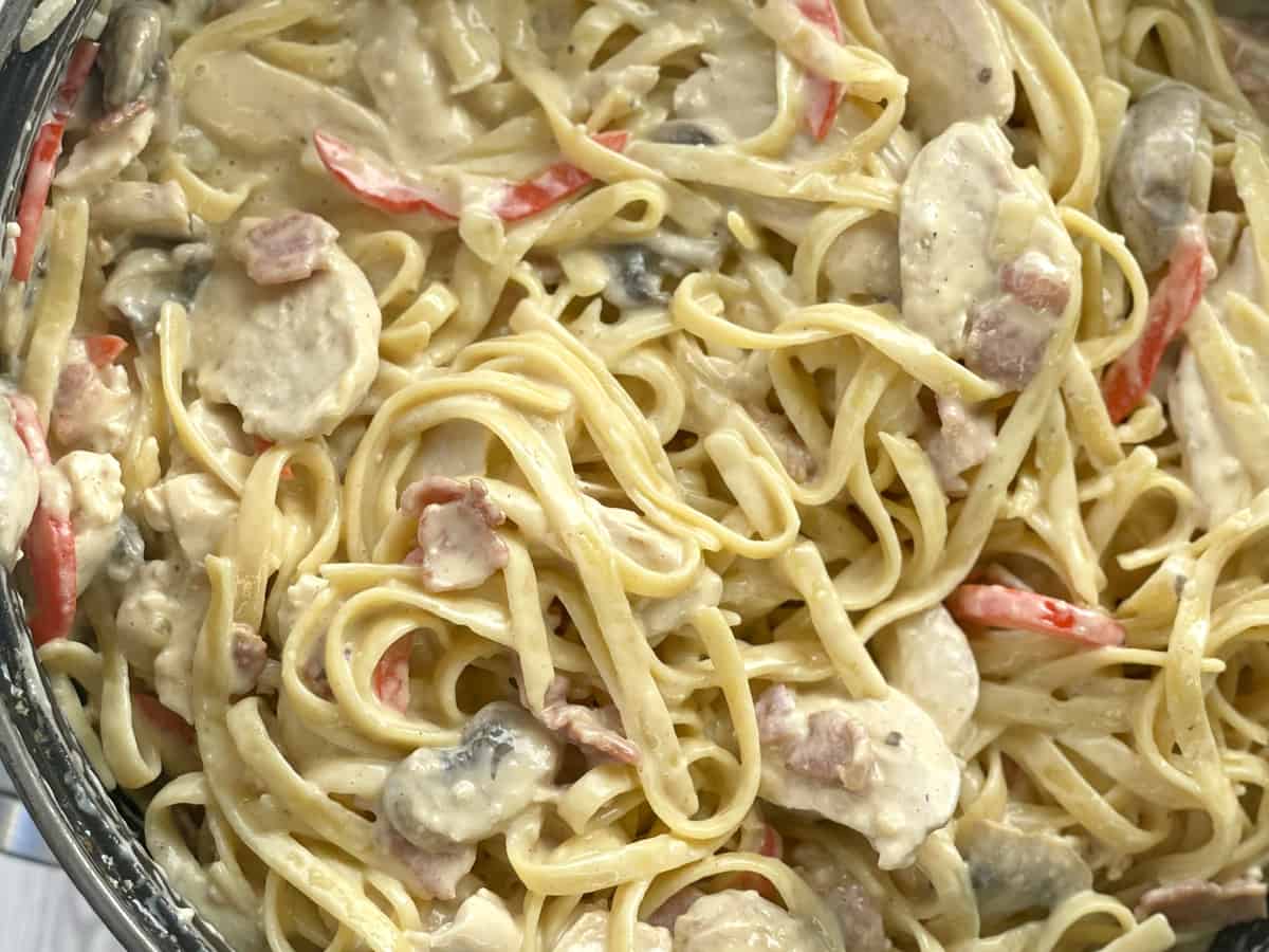 Decadent Pan full of creamy chicken and bacon pasta 