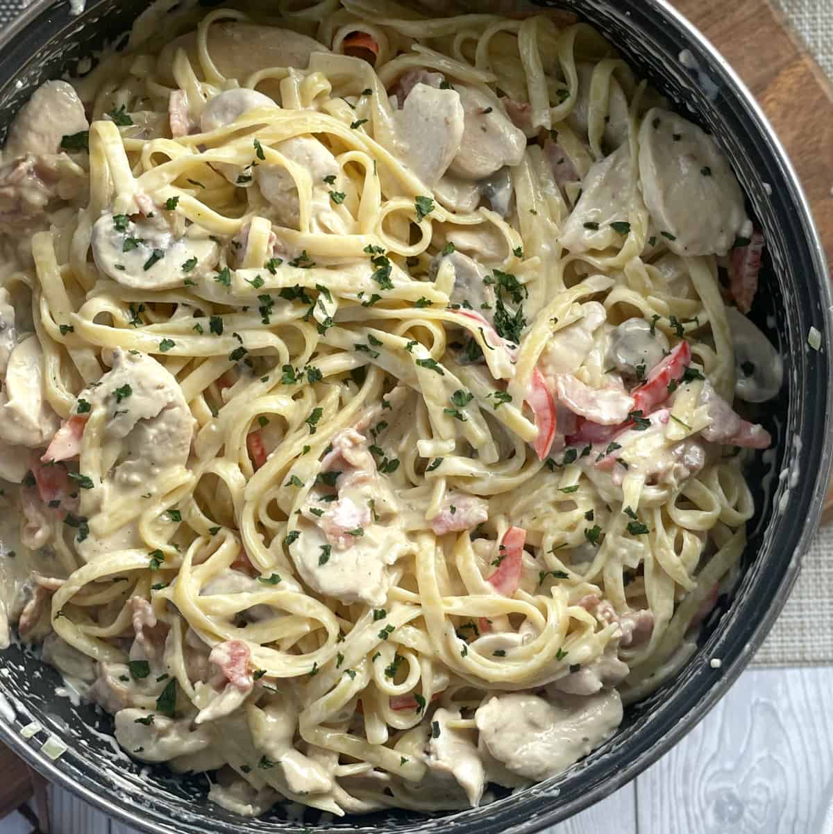 pan full of creamy chicken and bacon pasta 