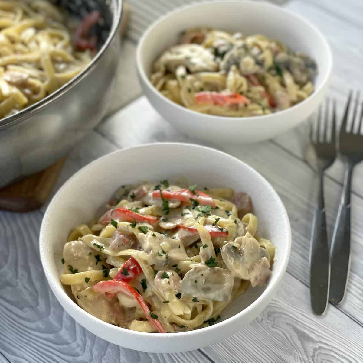 Two bowls of creamy bacon and chicken fettucine 