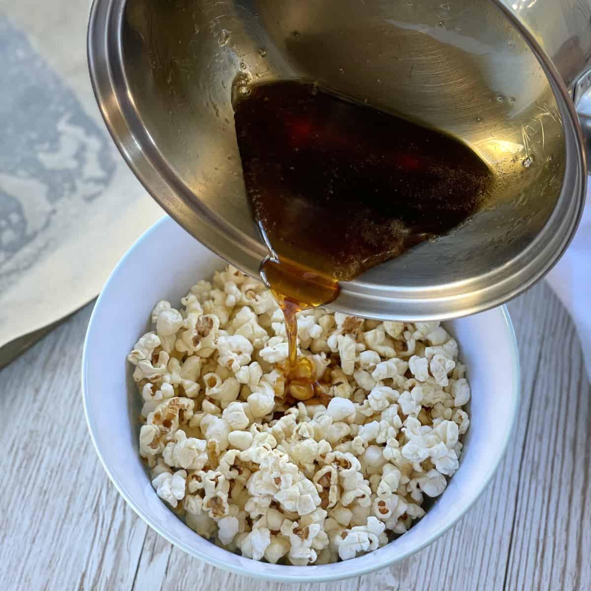 Pouring maple syrup over the popcorn 