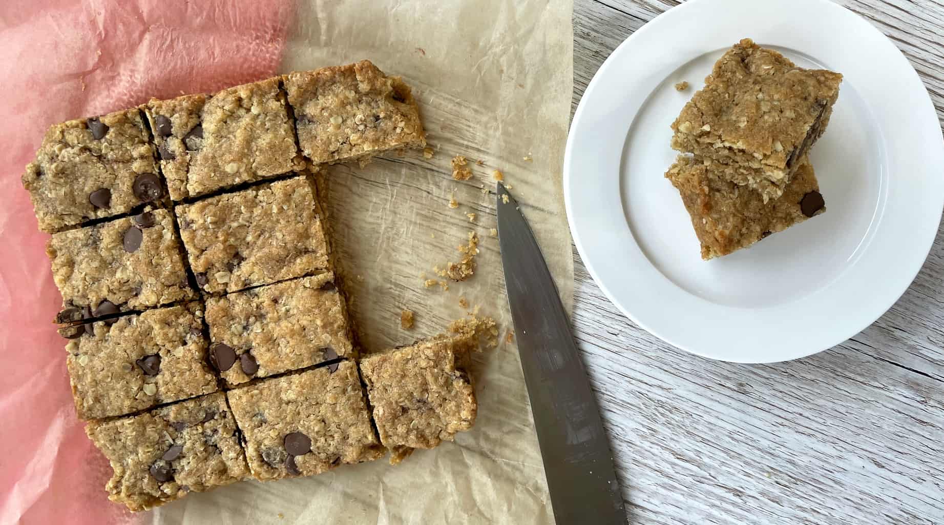 Overhead photograph of a oat slice with two pieces on a white plate 