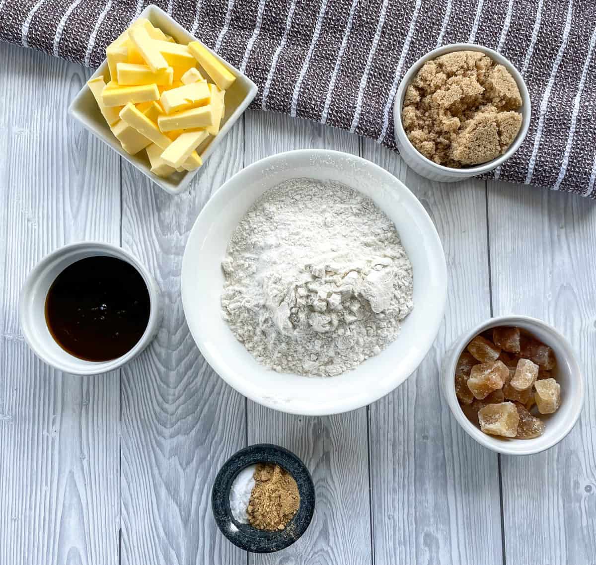 Overhead flatlay photo of the ingredients for ginger biscuits, see recipe card 