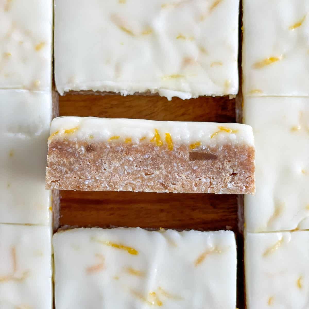 Close up of a side photo of a ginger no bake slice with a lemon icing 