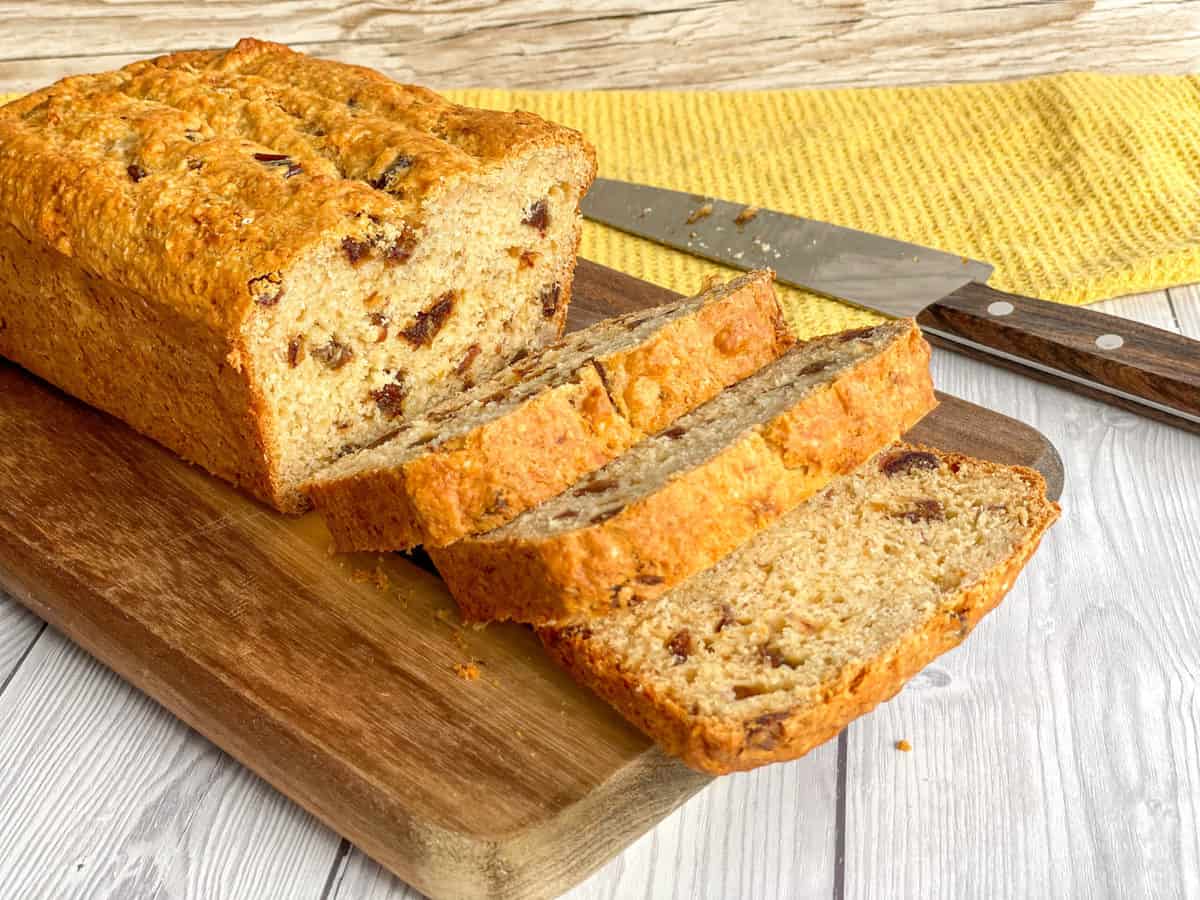 Thick Slices of banana and date loaf on a wooden chopping board 