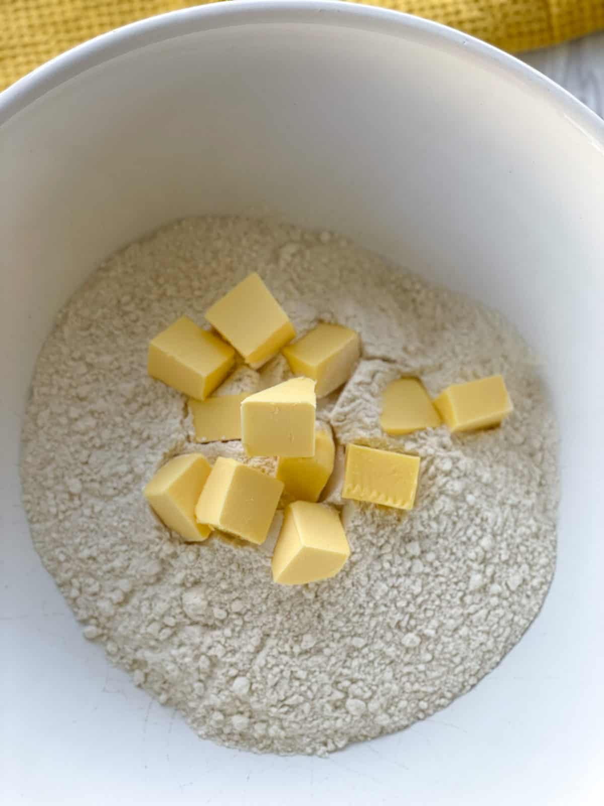 Self raising flour and butter in a white bowl 