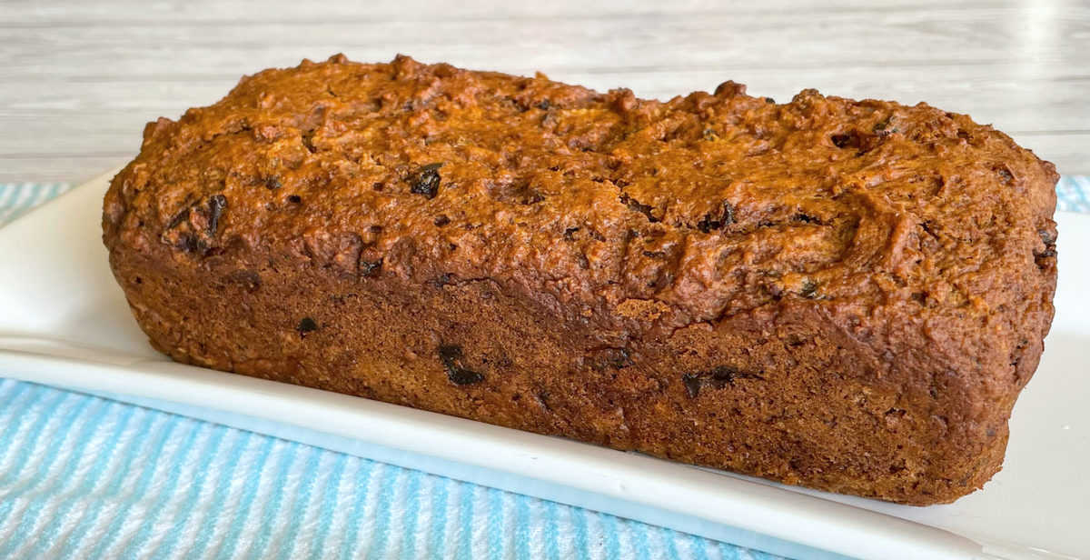 Weetbix and Date Loaf on a White Platter on a blue and white striped towel. 