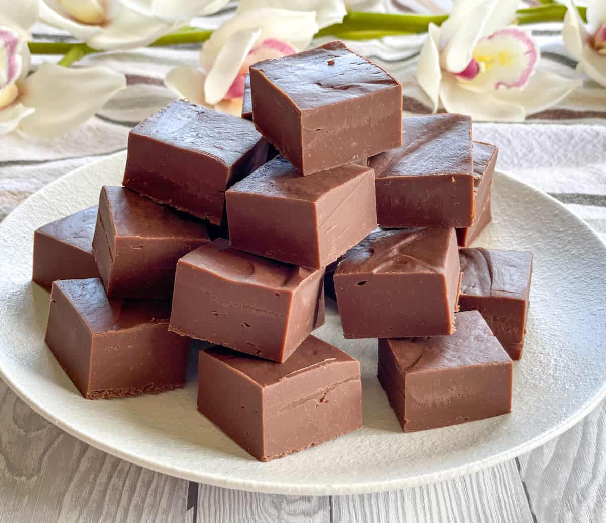 White plate piled high with milk chocolate fudge 