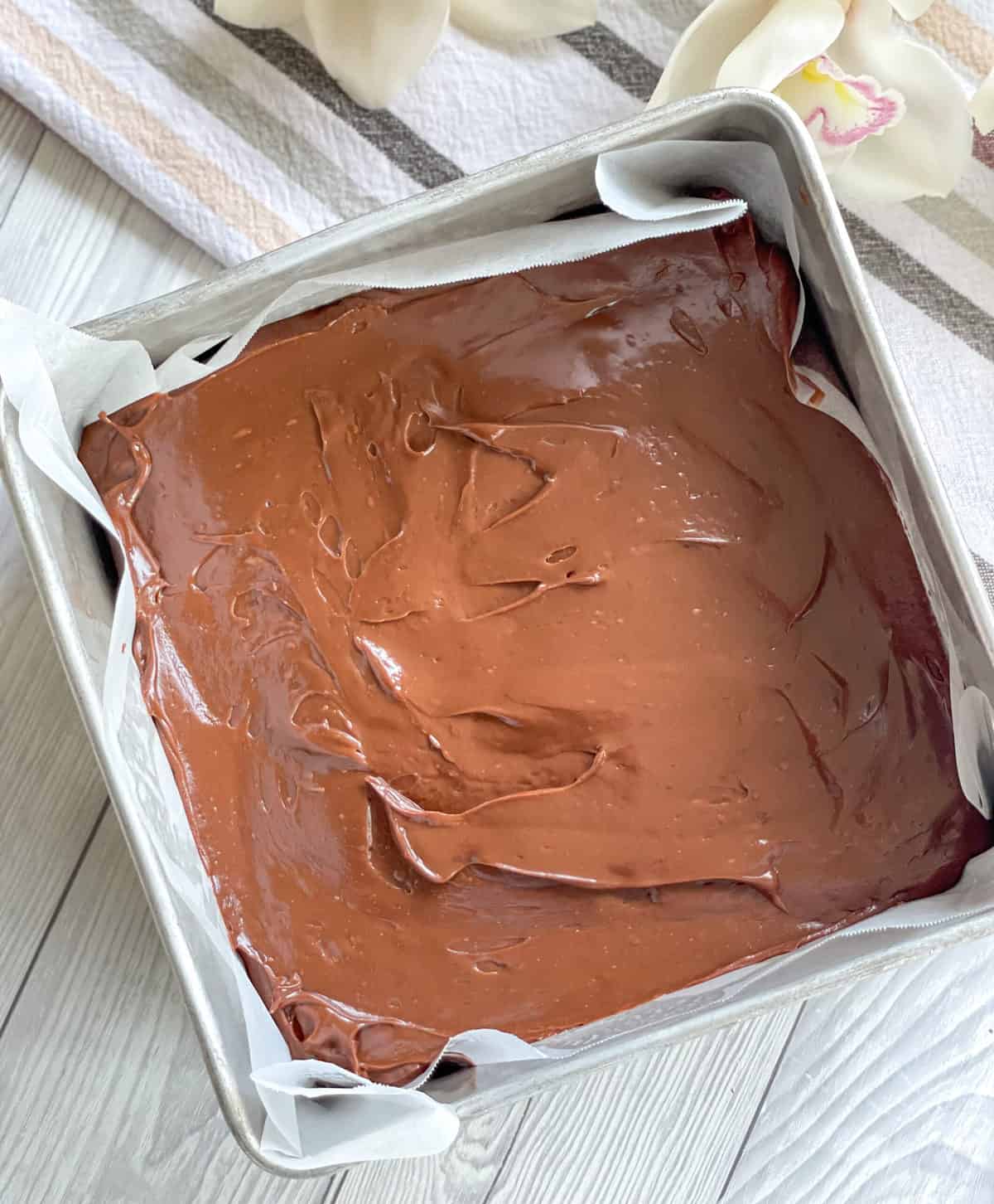 Fudge spread into a tin before chilling 