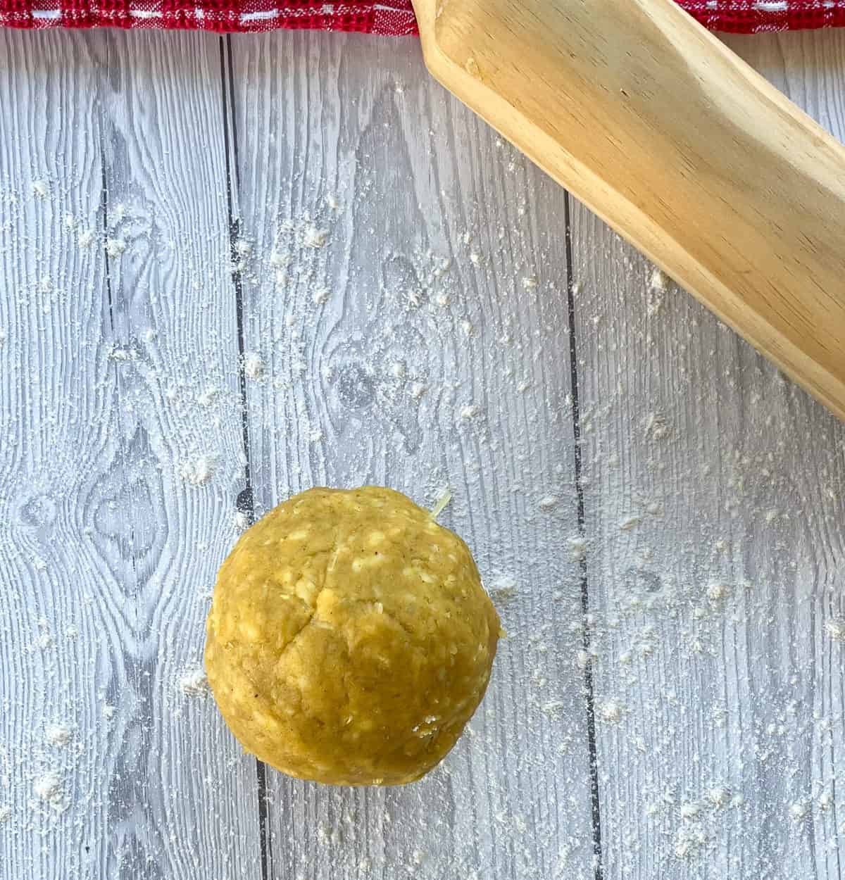 a ball of dough on a floured surface for the cheese and curry crackers 