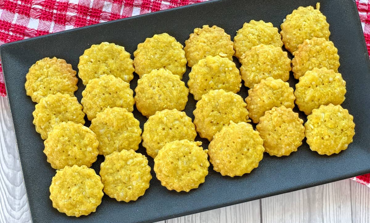 Crispy Curried Cheese Crackers served on a black platter 