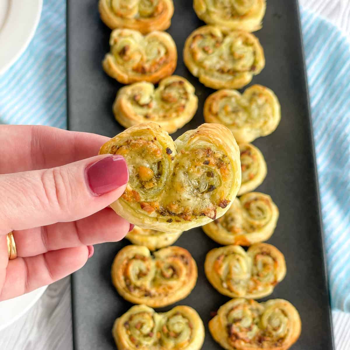 Hand holding a pesto palmier 