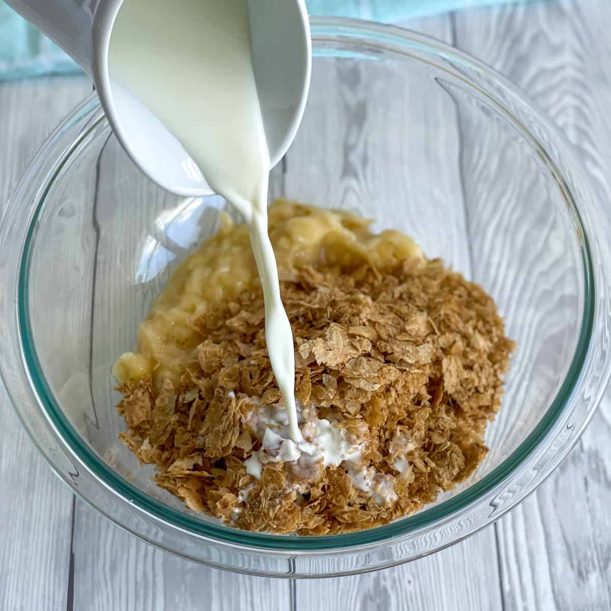 Milk pouring into a bowl with Weetbix and Banana 