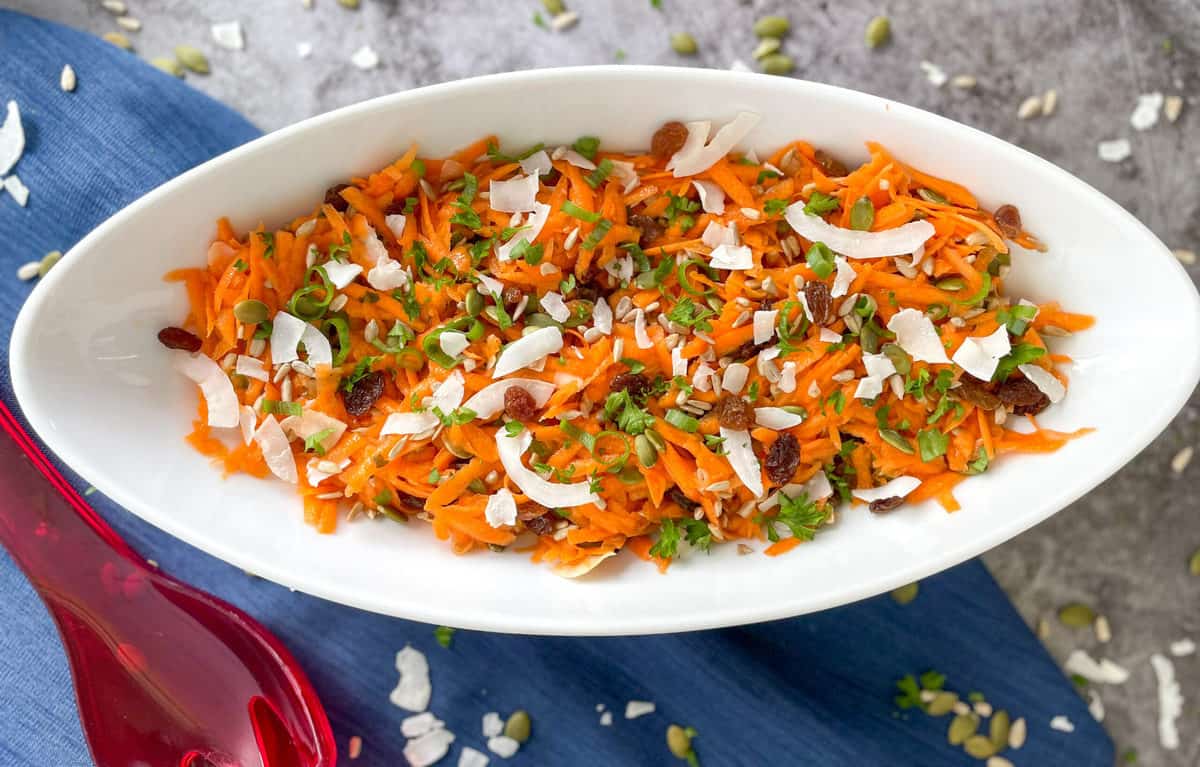 Carrot salad with seeds, raisins, coconut and dressing 