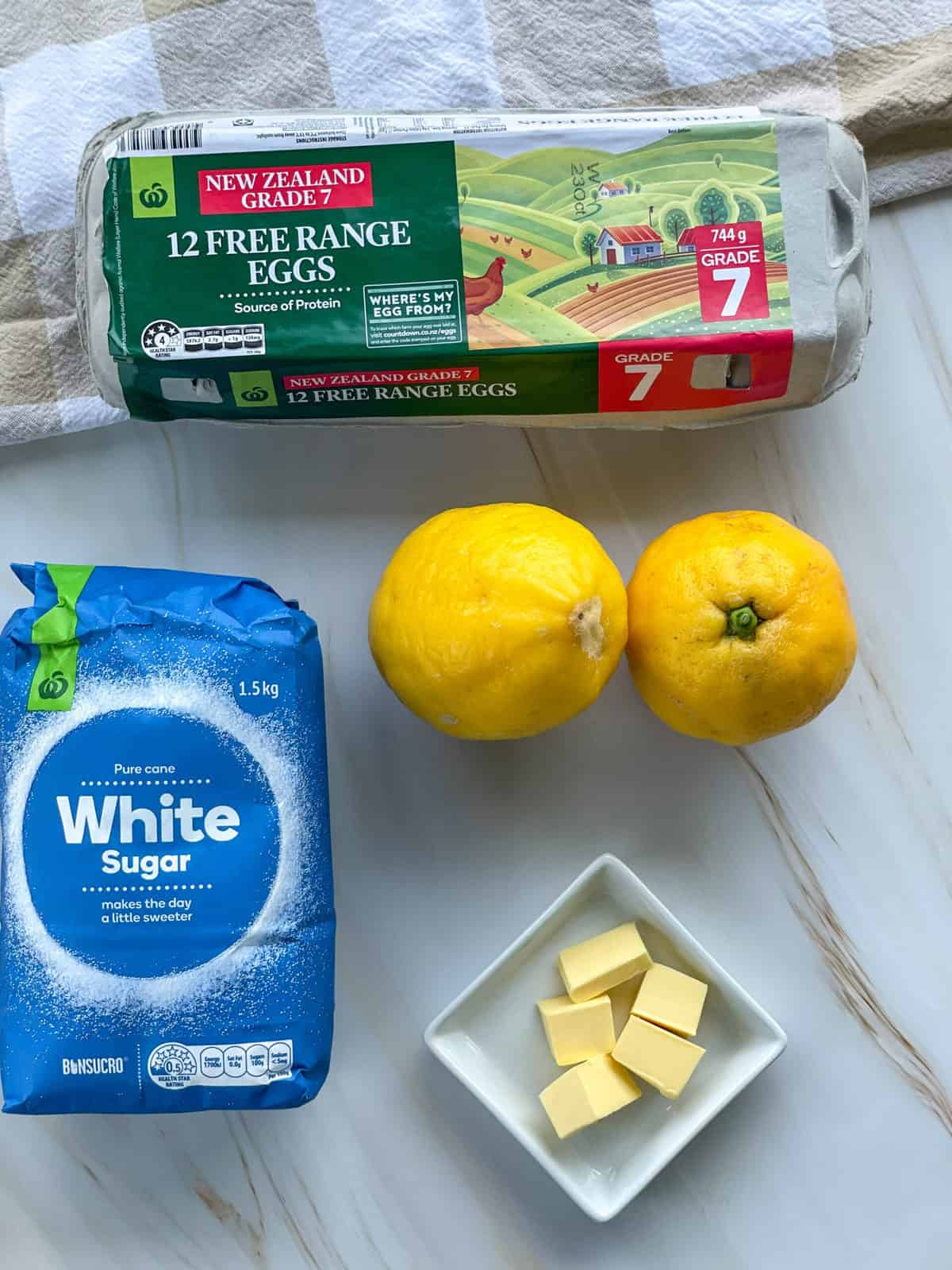 Ingredients used for lemon curd, sugar, eggs, butter and lemons 