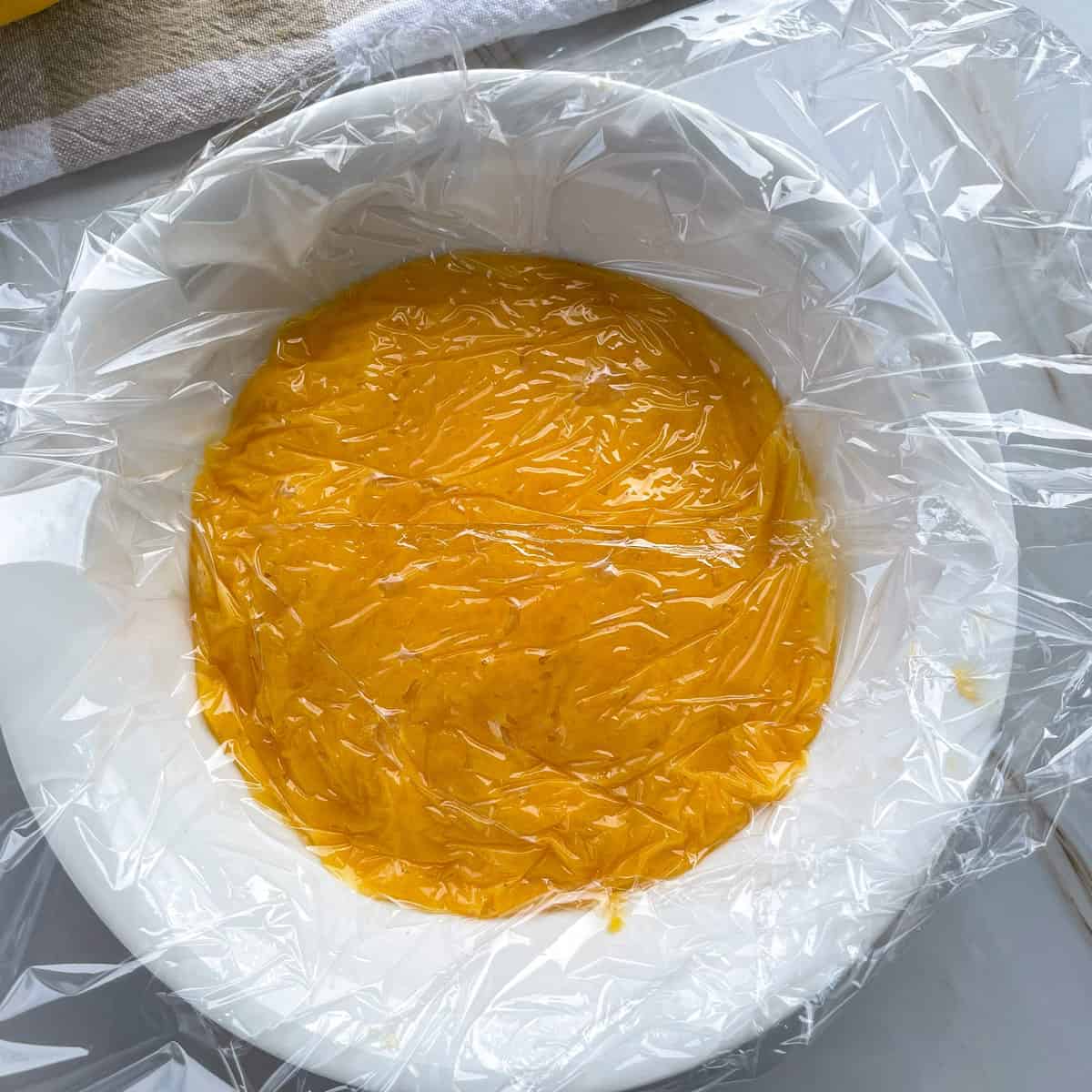 To allow lemon curd to set cover with plastic wrap and cool 