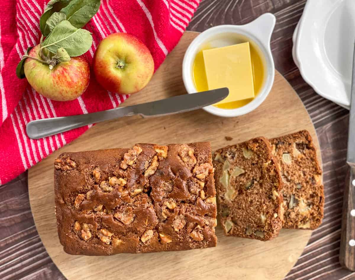 Overhead view of Apple and Walnut Loaf with melted butter and Apples