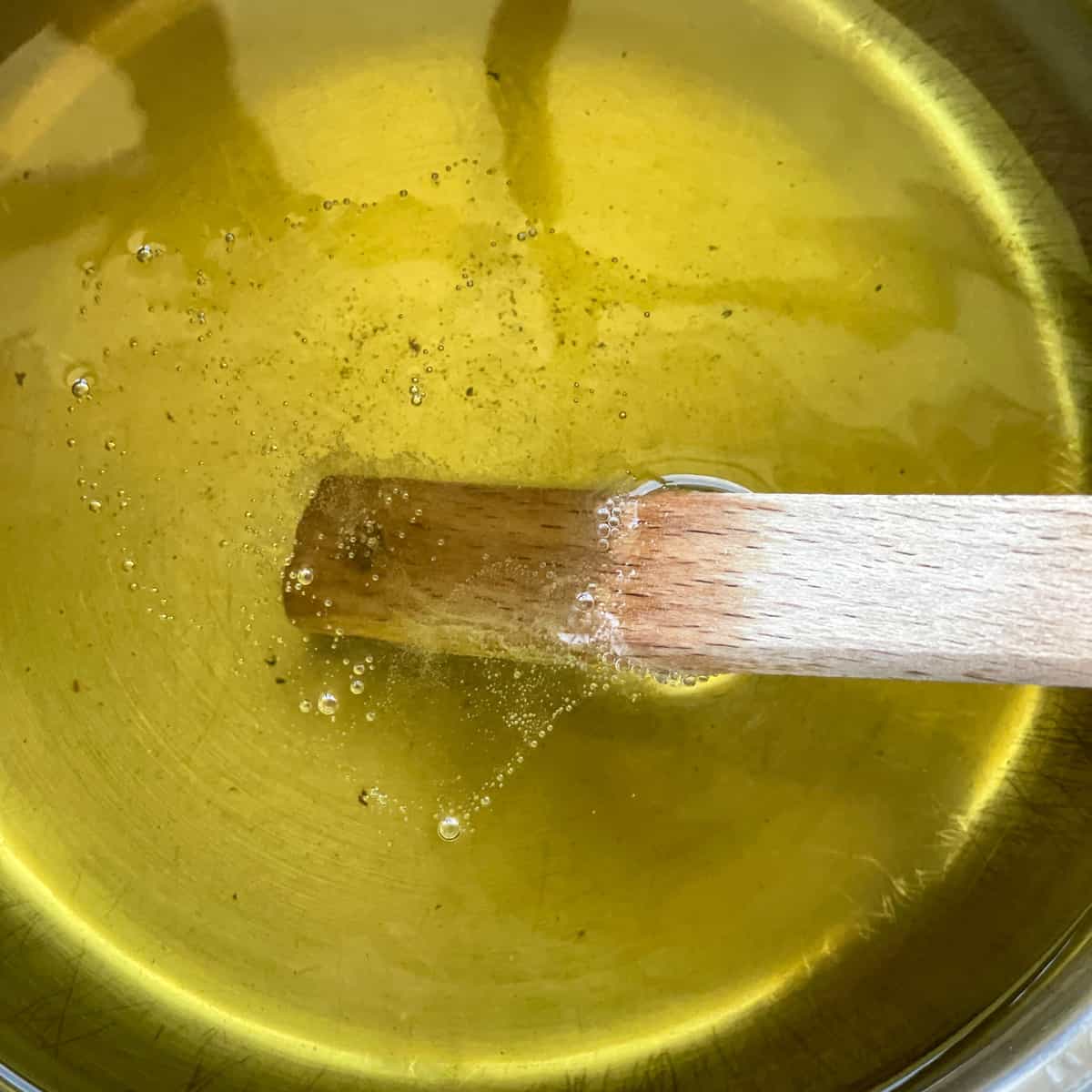 Test the oil with a wooden spoon to check if the right temperature for deep frying 