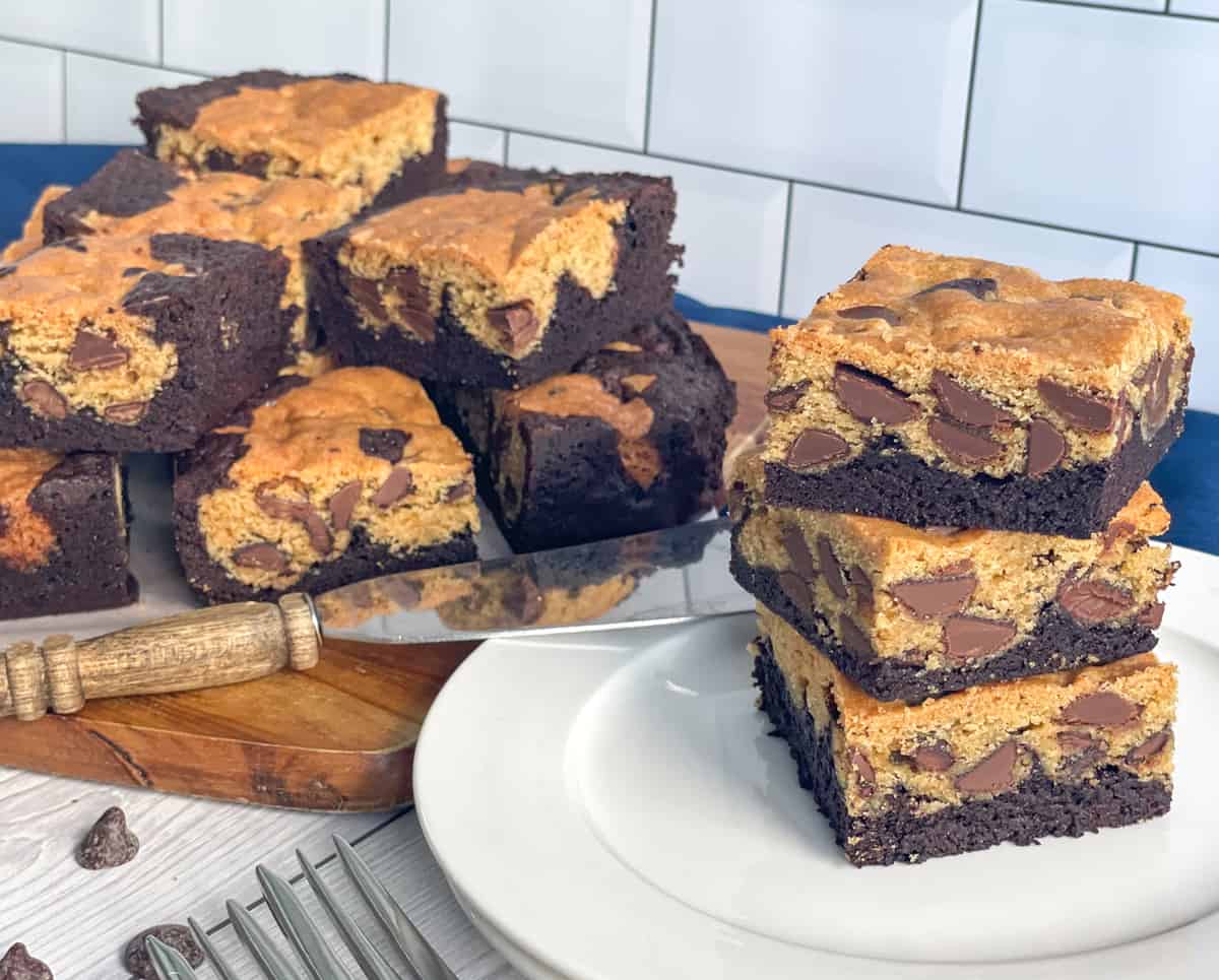 Brookies on a white plate in a stack, brownie and cookie slice 