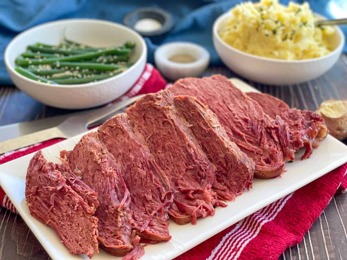 Slow Cooker Corned beef served with green beans and mashed potato
