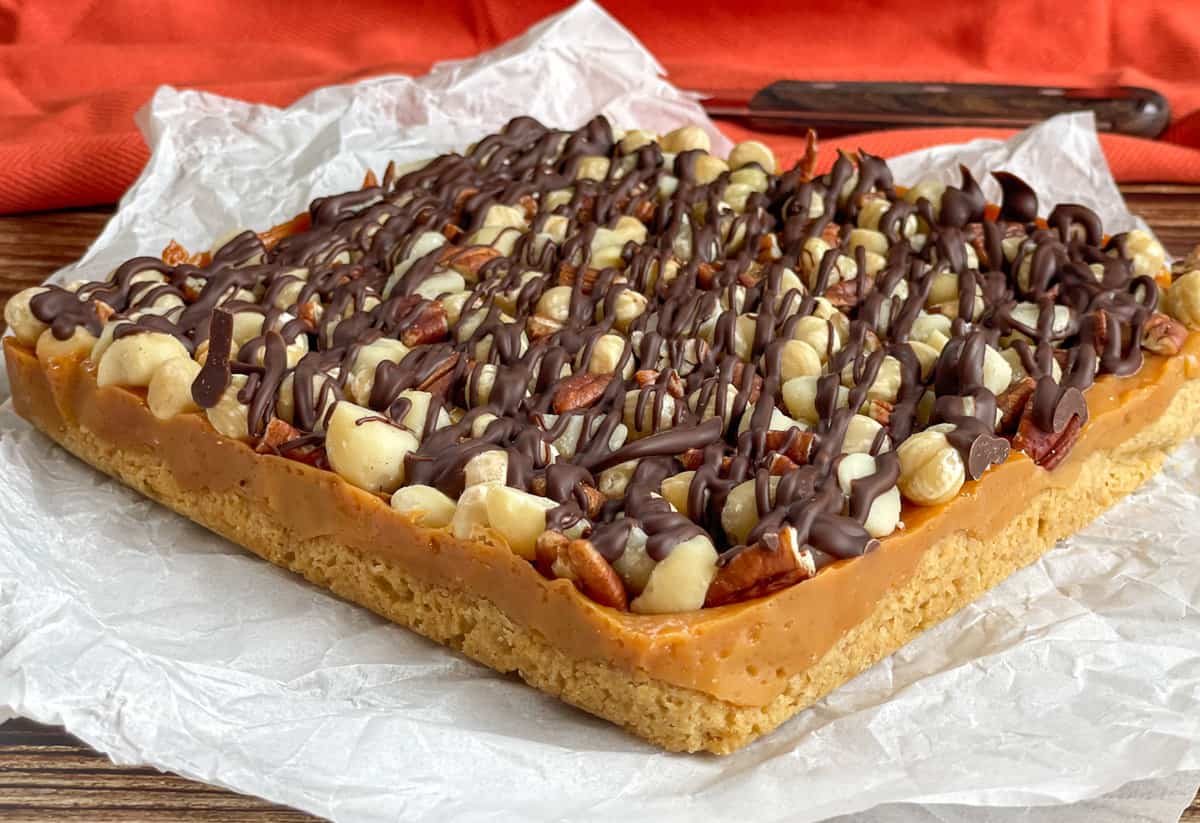 Close up image showing caramel and nut layers of the caramel nut slice 