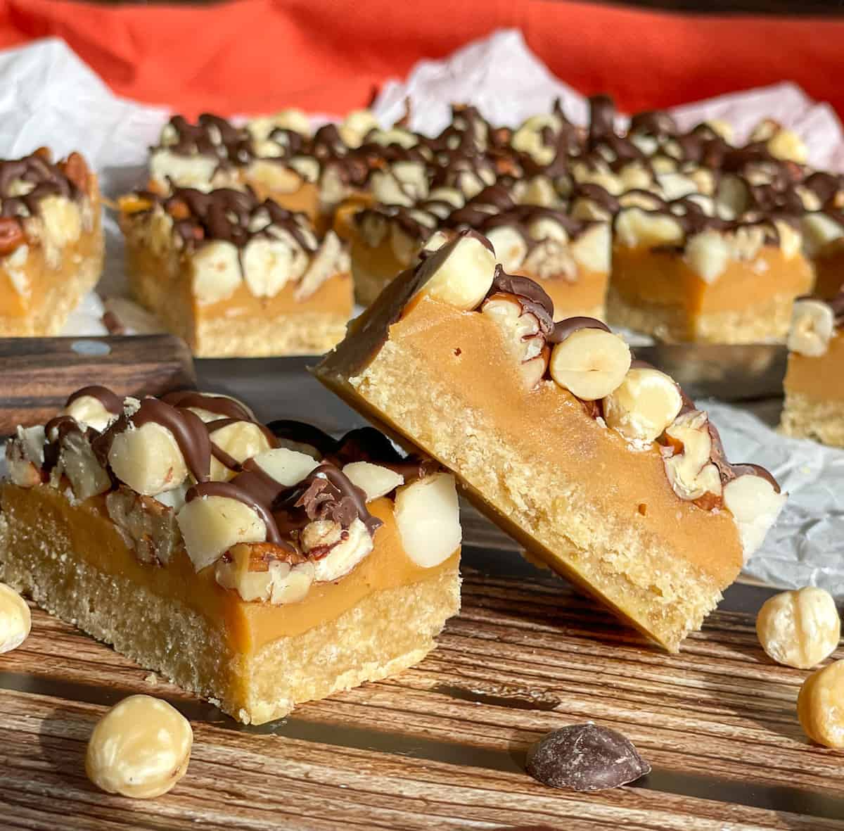 Pieces of caramel nut slice, drizzled with chocolate topping